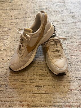Nike Women's Beige Sneakers with Gold Swoosh Accent
